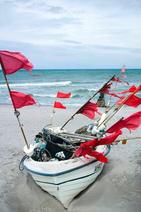 Small boats of coastal fishing lie on the beach in the Baltic resort of Ahrenshoop Ahrenshoop Copyright: FrankxHormannx xnordlicht