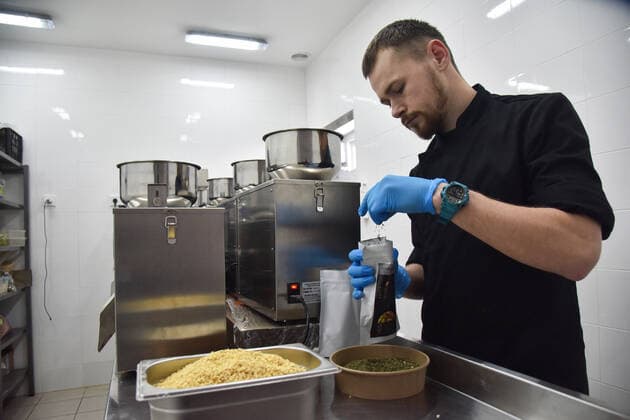 April 3, 2022, Lviv, Ukraine: A man works on a line for making dry rations in one of Lviv s food establishments for people affected by Russia s military invasion of Ukraine. The Central World Kitchen has funded the production of many thousands of packages of dry rations and energy bars for people affected by Russian troops. Production of these products was launched in one of Lviv s food establishments. Lviv Ukraine - ZUMAs197 20220403_zaa_s197_409 Copyright: xPavloxPalamarchukx