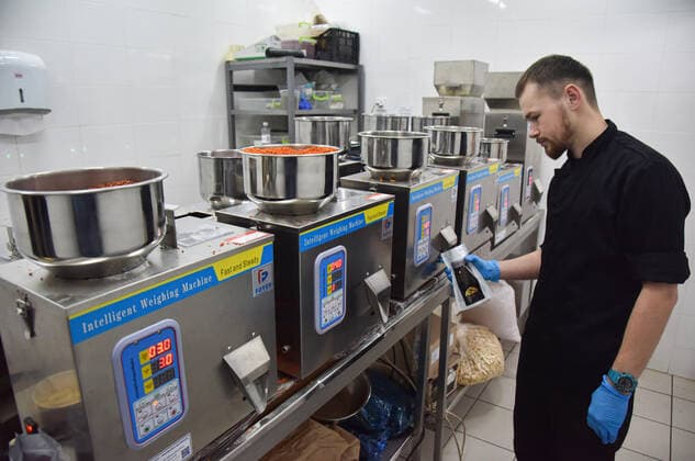 April 3, 2022, Lviv, Ukraine: A man works on a line for making dry rations in one of Lviv s food establishments for people affected by Russia s military invasion of Ukraine. The Central World Kitchen has funded the production of many thousands of packages of dry rations and energy bars for people affected by Russian troops. Production of these products was launched in one of Lviv s food establishments. Lviv Ukraine - ZUMAs197 20220403_zaa_s197_410 Copyright: xPavloxPalamarchukx