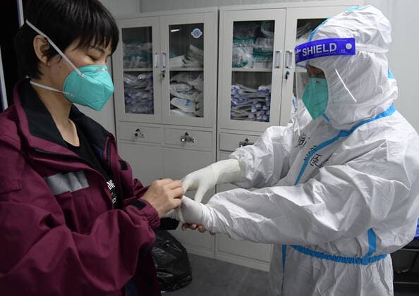 (220409) -- SHANGHAI, April 9, 2022 -- Supportive medics from Hainan Province prepare to enter the Jiading Nanxiang makeshift hospital for COVID-19 patients in east China s Shanghai, April 8, 2022. The Jiading Nanxiang makeshift hospital started operation on Friday, offering more than 1,700 beds for COVID-19 patients. ) CHINA-SHANGHAI-MAKESHIFT HOSPITAL-OPERATION (CN) LixHe 