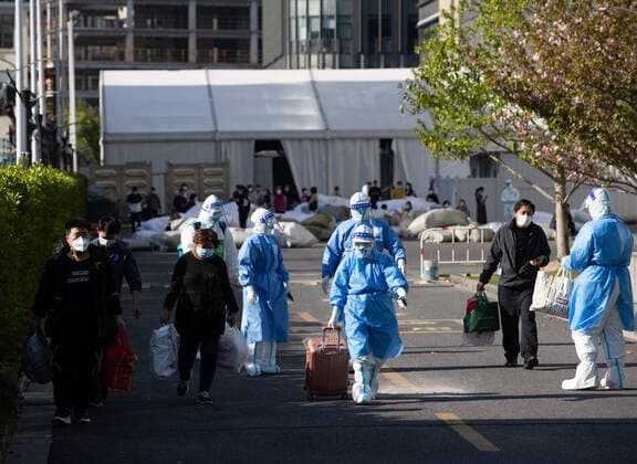 (220409) -- SHANGHAI, April 9, 2022 -- Patients who have recovered from COVID-19 leave a makeshift hospital converted from Shanghai Convention & Exhibition Center of International Sourcing in Shanghai, east China, April 9, 2022. The first group of 16 recovered COVID-19 patients left the makeshift hospital on Saturday. ) CHINA-SHANGHAI-PATIENTS-COVID-19-RECOVERY (CN) JinxLiwang 