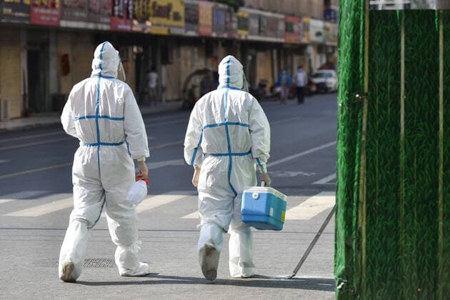 April 10, 2022, Fuyang, Anhui, China: Medical workers wearing Personal Protective Equipment (PPE) walk on a street that has been controlled because of COVID-19 in Fuyang. The Chinese mainland reported 1,318 new locally-transmitted confirmed covid-19 cases on Saturday, down from 1,334 on Friday, the National Health Commission said. Of the local confirmed cases reported Saturday, 1,006 were in Shanghai, 242 in Jilin, 16 in Zhejiang, 10 in Guangdong, and three in Beijing. The rest were reported in 12 other provincial-level regions. Fuyang China - ZUMAs197 20220410_zaa_s197_011 Copyright: xSheldonxCooperx