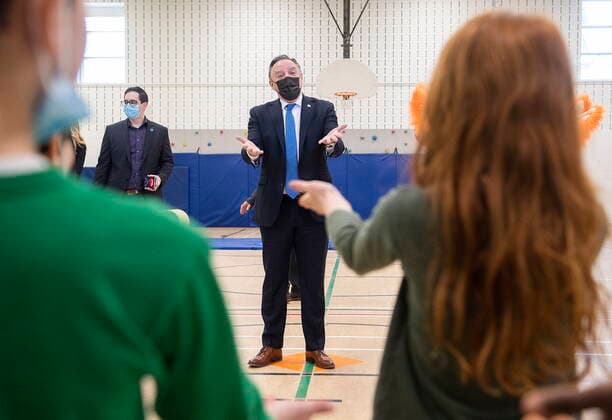 April 11, 2022, Montreal, PQ, Canada: Quebec Premier Francois Legault listens to a song by children during a visit to a school in Montreal, Monday, April 11, 2022. Montreal Canada  - ZUMAc35_ 20220411_zaf_c35_013 Copyright: xGrahamxHughesx