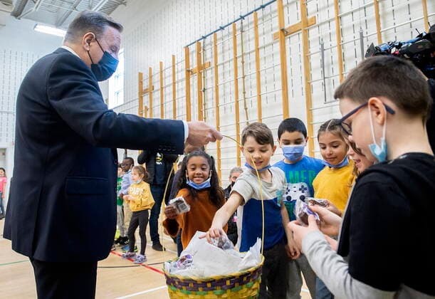 April 11, 2022, Montreal, PQ, Canada: Quebec Premier Francois Legault hands out chocolates to children during a visit to a school in Montreal, Monday, April 11, 2022. Montreal Canada  - ZUMAc35_ 20220411_zaf_c35_014 Copyright: xGrahamxHughesx
