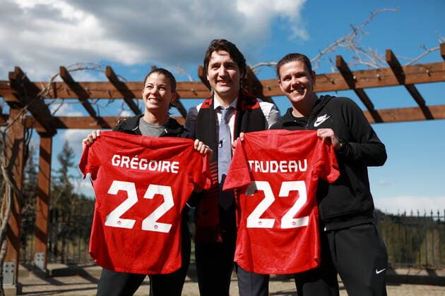 April 11, 2022, LANGFORD, BC, CAN: Prime Minister Justin Trudeau poses for a photo with Canada s Stephanie Labbe, left, and Christine Sinclair, left, and after being presented with an honourary team jersey during a surprise visit to the women s national soccer team warmup while at Bear Mountain Resort to wish them good luck before their game tonight in Langford, B.C., Monday, April 11, 2022. LANGFORD CAN - ZUMAc35_ 20220411_zaf_c35_082 Copyright: xChadxHipolitox