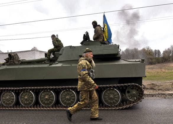 April 10, 2022, Bucha, Ukraine: A Ukrainian tank convoy stops on a road outside Bucha, Ukraine on April 11, 2022. Towns in the suburbs of Kyiv were liberated from Russian forces recently, leaving behind destruction and bodies amid claims of war crimes and atrocities commited. Bucha Ukraine - ZUMAg208 20220410_zap_g208_010 Copyright: xCarolxGuzyx