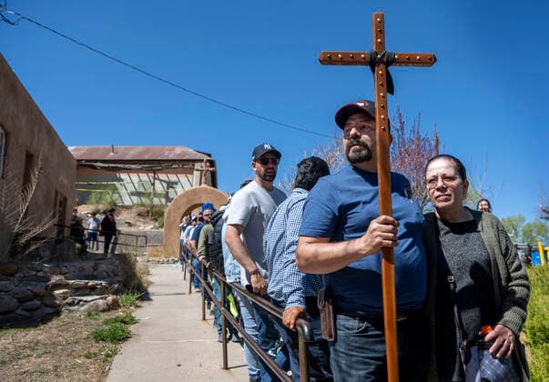 April 15, 2022, USA: Jorge and Alicia Lozoya, from Santa Fe, wait with hundreds of others to enter the Santuario de Chimayo after their Good Friday Pilgrimage. After two years of almost no Good Friday Pilgrimage thousands made the treck this year to the northern New Mexico church, Friday April 15, 2022. USA - ZUMAab1_ 20220415_zaf_ab1_019 Copyright: xEddiexMoorex