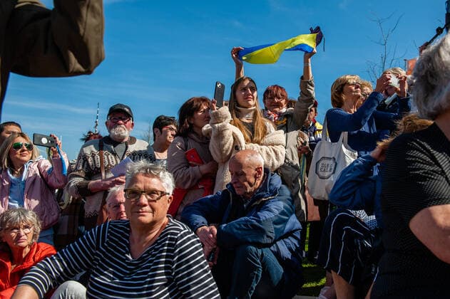 April 16, 2022, Nijmegen, Gelderland, Netherlands: A Ukrainian woman is seen holding a Ukrainian flag in the middle of the crowd. Under the motto, music connects people , the Nijmegen musician Mart Heijmans brought together 400 musicians at the Waalkade to sing the Ukrainian national anthem and other songs to show their solidarity with Ukraine. Around 250 of them were Ukrainian refugees received during the last months in the city. Four Ukrainian singers who have fled, including an opera singer, performed a few more songs before an attentive and emotional crowd. Nijmegen Netherlands - ZUMAs197 20220416_zaa_s197_058 Copyright: xAnaxFernandezx