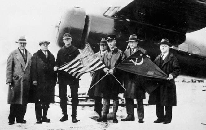 SLEPNYOV FARIKH ALASKA NOME 24441 17.04.1930 Soviet pilots Mavriky Slepnyov third right with flags and Fabio Farikh with representatives of U.S. State Department at airport of Nome town after delivering the bodies of U.S. pilots Carl Ben Eielson and Earl Borland. RIA Novosti Sputnik Nom USA  Copyright: xRIAxNovostix