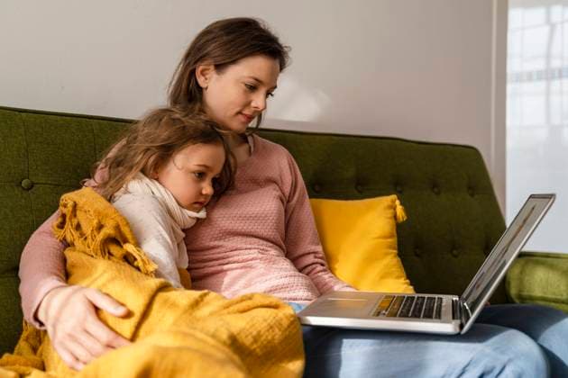 Mother with sick daughter consulting doctor online through laptop model released, Symbolfoto property released, DIGF17740