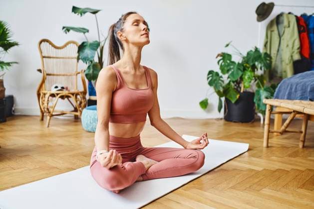 IMAGO Creative: 2022 Sport Favoriten Woman meditating on exercise mat at home model released, Symbolfoto property released, BSZF02033