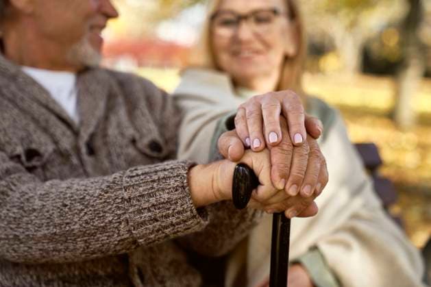 Senior couple with walking stick sitting together model released, Symbolfoto, ABIF01634