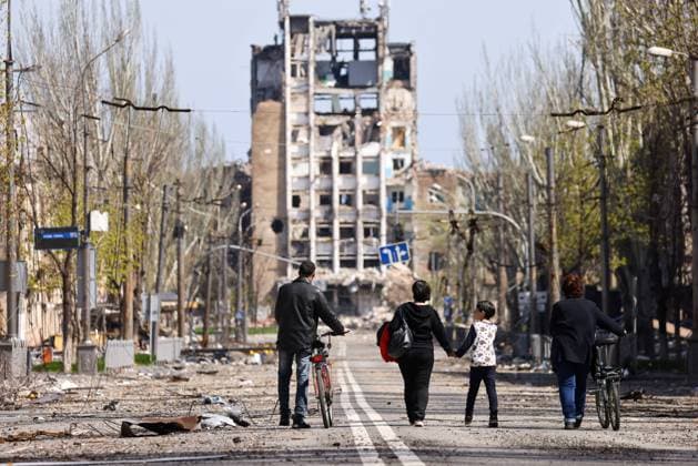 DONETSK REGION, UKRANIE - APRIL 24, 2022: Citizens walk along one of the streets in the embattled city of Mariupol. With tension escalating in Donbass in February, the Russian Armed Forces launched a special military operation in Ukraine in response to appeals for help from the Donetsk and Lugansk People s Republics. Peter Kovalev TASS  TS12E45A
