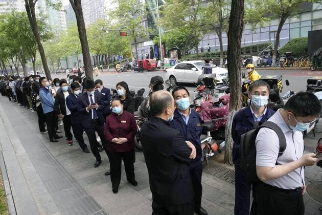 Tighter COVID controls in Beijing People form a line to take PCR tests in Beijing on April 25, 2022, after authorities announced tighter controls against COVID-19.  A14AA0001283689P
