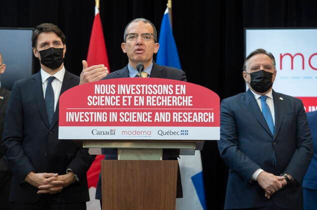 April 29, 2022, Montreal, PQ, Canada: Quebec Premier Francois Legault, right, and Prime Minister Justin Trudeau, left, look on as Moderna global CEO Stephane Bancel speaks during an announcement of the opening of a Moderna vaccine production and research facility in Montreal, Friday, April 29, 2022. Montreal Canada  - ZUMAc35_ 20220429_zaf_c35_041 Copyright: xGrahamxHughesx