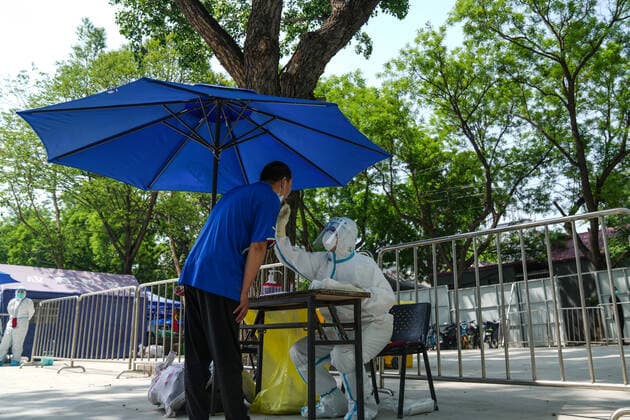 (220505) -- BEIJING, May 5, 2022 -- A medical worker takes a swab sample from a resident for a nucleic acid test in Xicheng District, Beijing, capital of China, May 5, 2022. Beijing s 12 districts have carried out three rounds of nucleic acid screening from Tuesday till Thursday on a daily basis to curb the COVID-19 resurgence. ) CHINA-BEIJING-THREE ROUNDS OF NUCLEIC ACID SCREENING (CN) PengxZiyang 