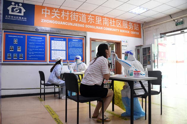 (220505) -- BEIJING, May 5, 2022 -- A medical worker takes a swab sample from a resident for a nucleic acid test in Haidian District, Beijing, capital of China, May 5, 2022. Beijing s 12 districts have carried out three rounds of nucleic acid screening from Tuesday till Thursday on a daily basis to curb the COVID-19 resurgence. ) CHINA-BEIJING-THREE ROUNDS OF NUCLEIC ACID SCREENING (CN) RenxChao 