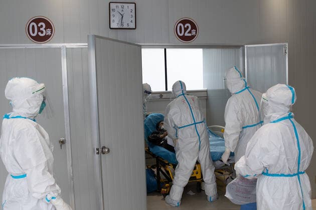 (220510) -- SHANGHAI, May 10, 2022 -- Meng Xiangjun and Zhang Zhimin transfer a COVID-19 patient in east China s Shanghai, May 9, 2022. A medical emergency team consisting of 108 members with 50 ambulances from north China s Tianjin has arrived at Shanghai to assist in the city s public medical emergency service amid the COVID-19 resurgence. ) CHINA-SHANGHAI-MEDICAL TEAM-COVID-19-AID (CN) JinxLiwang 