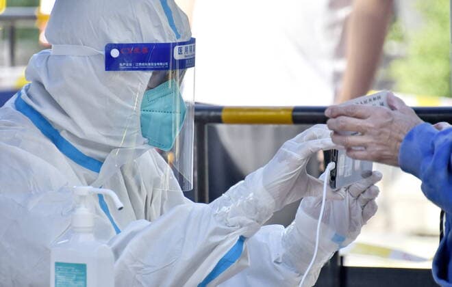 (220513) -- BEIJING, May 13, 2022 -- A staff member helps a citizen to register information before nucleic acid testing in Chaoyang District of Beijing, capital of China, May 13, 2022. Beijing plans to conduct three rounds of mass nucleic acid testing in 12 districts from Friday to Sunday. ) CHINA-BEIJING-COVID-19-NUCLEIC ACID TESTING (CN) LixXin 