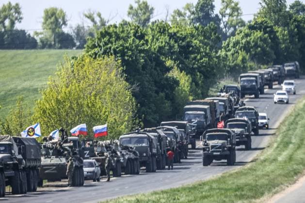 MARIUPOL, UKRAINE - MAY 13, 2022: A convoy of military hardware and vehicles with Russian flags are seen on a road in the city of Mariupol which is under control of the Donetsk People s Republic. The Russian Armed Forces are carrying out a special military operation in Ukraine in response to requests from the leaders of the Donetsk People s Republic and Lugansk People s Republic for assistance. Peter Kovalev TASS  TS131030