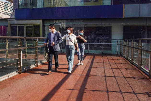 May 17, 2022, Changzhou, China: Three pedestrians wearing face masks as a preventive measure against the spread of coronavirus walk on the overpass. According to China s economy is supposed to see improvement this month despite weak business data in April, and economic activities may rebound with a gradual recovery in household spending and strong fixed-investment support in the following months, officials and experts said on Monday. They said China s economy should gradually stabilize and recover, with improvement in some key economic indicators, better containment of COVID-19 outbreaks and stronger policy support. Changzhou China - ZUMAs197 20220517_zaa_s197_378 Copyright: xSheldonxCooperx