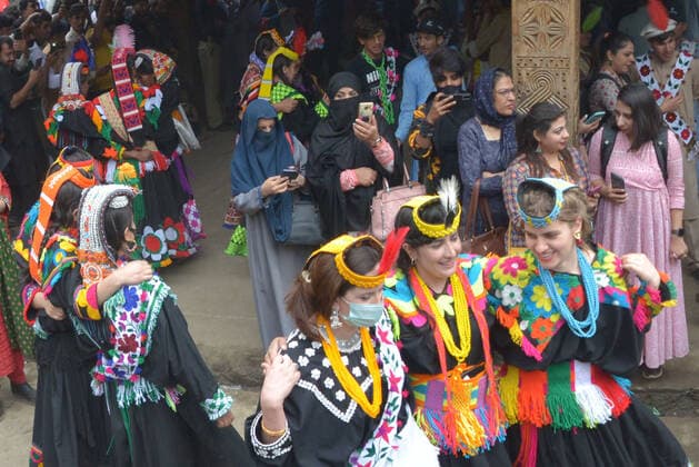Pakistan: Chilmjushi Festival in the Kalsh Valley Kalashi women and men wearing traditional dresses participating in the dance during the Chilmjushi Festival in the Kalsh Valley. Chilum Joshi is also known as a Kalash spring festivals. Dressed up in newly knitted clothes with elaborate headgear and jewelry in vibrant colors , Kalasha women dance to traditional drumbeats during the chilum joshi festivals that concluded here at the scenic Bamburet valley on Sunday with fanfare. The four days event attracted an unprecedented number of tourists including a group of 22 Malaysian motorcyclists, besides the French, Australian and Italian nationals, on the concluding day of the festival young men women select their life partners while each day f Copyright: RanaxSajidxHussain