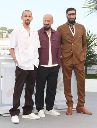 Israeli-Palestinian actor Tawfeek Barholm, Swedish director Tarik Saleh and Swedish actor Fares Fares attend the photo call for Boy From Heaven at Palais des Festivals at the 75th Cannes Film Festival, France on Saturday, May 21, 2022.  CAN20220521115 RUNExHELLESTAD