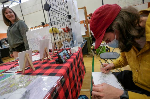 (220522) -- VANCOUVER, May 22, 2022 -- A comic artist draws at his booth during the Vancouver Comic Art Festival in Vancouver, British Columbia, Canada, on May 22, 2022. The Vancouver Comic Art Festival, an annual celebration of comics and graphic novels and their creators, features over one hundred of comic creators from around the world this year. (Photo by Xinhua) CANADA-VANCOUVER-COMIC ART FESTIVAL LiangxSen 
