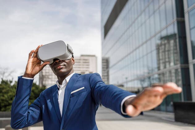 Creative Highlights Symbolbilder Businessman wearing virtual reality simulator gesturing outside modern office building model released, Symbolfoto, IFRF01650