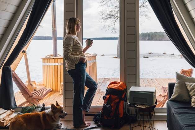 Woman enjoying drink leaning by glass door at home model released, Symbolfoto property released, VPIF05936
