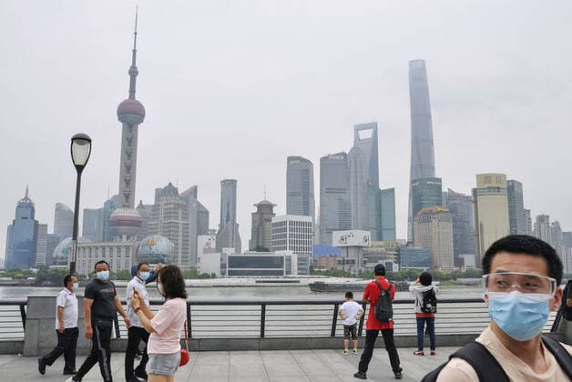 Shanghai lifts 2-month-long lockdown People wearing face masks walk in Shanghai on June 1, 2022, as the Chinese city lifts its two-month-long lockdown, allowing around 90 percent of its residents to leave home and resuming public transport.  A14AA0001295672P
