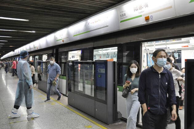 Shanghai lifts 2-month-long lockdown People wearing face masks get on and off a subway train in Shanghai on June 1, 2022, as the Chinese city lifts its two-month-long lockdown, allowing around 90 percent of its residents to leave home.  A14AA0001295735P
