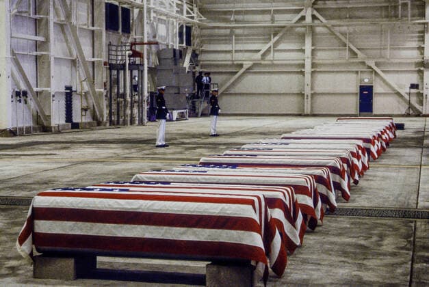 October 29, 1983 - Dover, Delaware, U.S - Dover, Delaware. USA, 29th October, 1983.At precisely 7 A.M., a Marine honor guard and a color guard in ceremonial dress uniforms marched into a huge hangar at the Dover Air Force Base and stood facing 16 coffins. Behind them, suspended from the beams of the hangar, was a 38-foot American flag..The ceremony was the first on American soil honoring servicemen killed in the bombing in Beirut and the invasion of Grenada. Dover U.S. - ZUMAr142 1012556836st Copyright: xMarkxReinsteinx