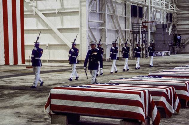 October 29, 1983 - Dover, Delaware, U.S - Dover, Delaware. USA, 29th Ocotber, 1983.At precisely 7 A.M., a Marine honor guard and a color guard in ceremonial dress uniforms marched into a huge hangar at the Dover Air Force Base and stood facing 16 coffins. Behind them, suspended from the beams of the hangar, was a 38-foot American flag..The ceremony was the first on American soil honoring servicemen killed in the bombing in Beirut and the invasion of Grenada. Dover U.S. - ZUMAr142 1012556837st Copyright: xMarkxReinsteinx