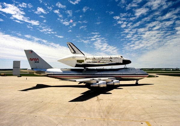 (23 March 1978) --- A side view of the huge space shuttle orbiter 102 Columbia mated atop its 747 carrier aircraft--NASA 905 in piggyback mode, ready for takeoff from Kelly Air Force Base. 1062_36_M_-11455-