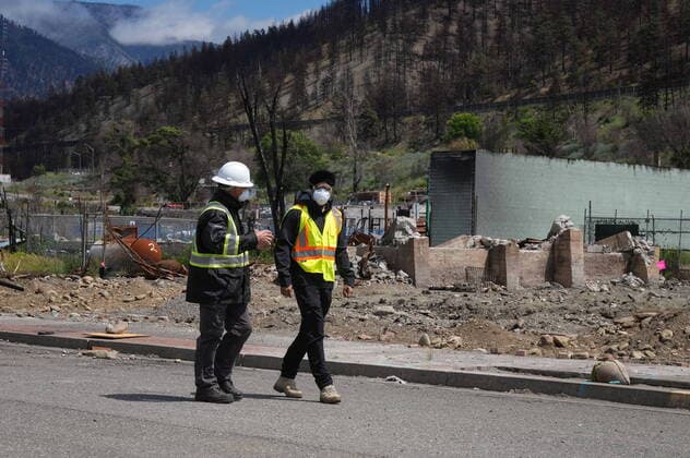 June 14, 2022, LYTTON, BC, CANADA: Harjit Sajjan, right, minister of International Development, views wildfire damage with Owen Collings, a resident who works as site support for the village, in Lytton, B.C., on Tuesday, June 14, 2022. The fire-ravaged community of Lytton, B.C., will get $77 million from the federal government to help it rebuild a fire-resistant and energy-efficient community. Two people were killed and much of the centre of the village was destroyed when wildfire ripped through the community almost a year ago. LYTTON CANADA  - ZUMAc35_ 20220614_zaf_c35_069 Copyright: xDarrylxDyckx