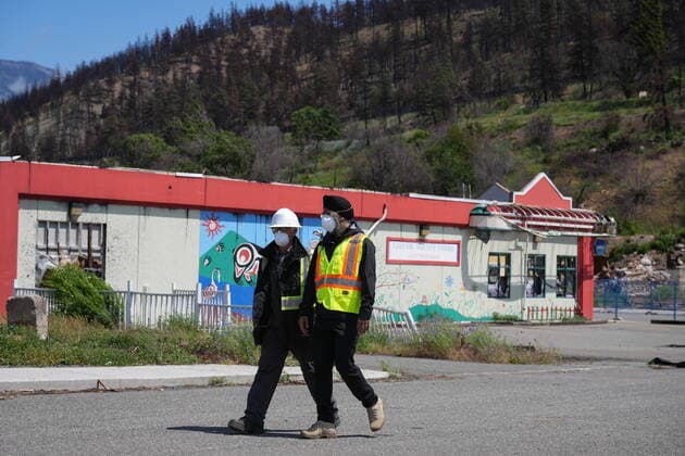 June 14, 2022, LYTTON, BC, CANADA: Harjit Sajjan, right, minister of International Development, views wildfire damage with Owen Collings, a resident who works as site support for the village, in Lytton, B.C., on Tuesday, June 14, 2022. The fire-ravaged community of Lytton, B.C., will get $77 million from the federal government to help it rebuild a fire-resistant and energy-efficient community. Two people were killed and much of the centre of the village was destroyed when wildfire ripped through the community almost a year ago. LYTTON CANADA  - ZUMAc35_ 20220614_zaf_c35_073 Copyright: xDarrylxDyckx
