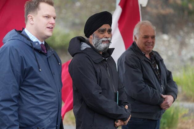 June 14, 2022, LYTTON, BC, CANADA: Harjit Sajjan, centre, minister of International Development, stands with Conservative MP Brad Vis, left, and Lytton Mayor Jan Polderman, right, after speaking during an announcement about funding to rebuild the village of Lytton, B.C., on Tuesday, June 14, 2022. The fire-ravaged community of Lytton, B.C., will get $77 million from the federal government to help it rebuild a fire-resistant and energy-efficient community. Two people were killed and much of the centre of the village was destroyed when wildfire ripped through the community almost a year ago. LYTTON CANADA  - ZUMAc35_ 20220614_zaf_c35_099 Copyright: xDarrylxDyckx