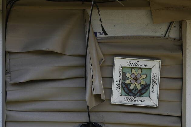 June 14, 2022, LYTTON, BC, CANADA: Melted vinyl siding and a welcome sign are seen on a house that remains standing after last year s devastating wildfire, in Lytton, B.C., on Tuesday, June 14, 2022. The fire-ravaged community of Lytton, B.C., will get $77 million from the federal government to help it rebuild a fire-resistant and energy-efficient community. Two people were killed and much of the centre of the village was destroyed when wildfire ripped through the community almost a year ago. LYTTON CANADA  - ZUMAc35_ 20220614_zaf_c35_100 Copyright: xDarrylxDyckx