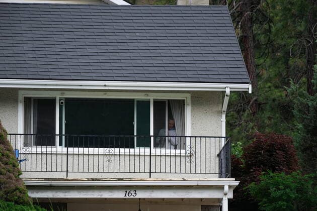 June 14, 2022, LYTTON, BC, CANADA: A resident watches from a house above the Trans-Canada Highway as Harjit Sajjan, minister of International Development, speaks during an announcement about funding to rebuild the village of Lytton, B.C., on Tuesday, June 14, 2022. The fire-ravaged community of Lytton, B.C., will get $77 million from the federal government to help it rebuild a fire-resistant and energy-efficient community. Two people were killed and much of the centre of the village was destroyed when wildfire ripped through the community almost a year ago. LYTTON CANADA  - ZUMAc35_ 20220614_zaf_c35_103 Copyright: xDarrylxDyckx