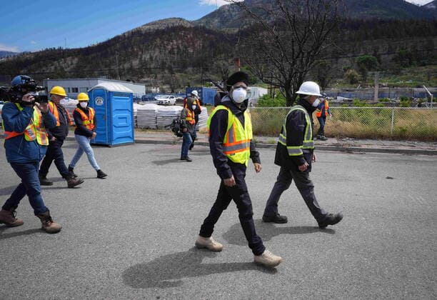 June 14, 2022, LYTTON, BC, CANADA: Harjit Sajjan, centre, minister of International Development, views wildfire damage with Owen Collings, right, a resident who works as site support for the village, in Lytton, B.C., on Tuesday, June 14, 2022. The fire-ravaged community of Lytton, B.C., will get $77 million from the federal government to help it rebuild a fire-resistant and energy-efficient community. Two people were killed and much of the centre of the village was destroyed when wildfire ripped through the community almost a year ago. LYTTON CANADA  - ZUMAc35_ 20220614_zaf_c35_072 Copyright: xDarrylxDyckx