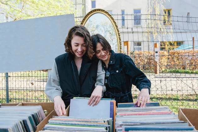 Smiling lesbian couple selecting records at market stall Germany, Berlin, model released Copyright: xMaskotx , MA94160