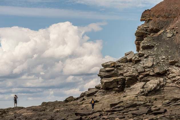 Tourists observe the Joggins Fossil Cliffs UNESCO World Heritage Site along the shore of the Bay of Fundy in Nova Scotia. May 2017.  1575744 NickxHawkins
