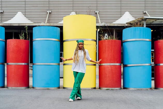 Woman wearing bandana dancing in front of concrete pipes model released, Symbolfoto, MEUF05706