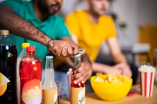 Hands of young man opening bottle of drink at home model released, Symbolfoto property released, Florence Florence Italy SBAF00097