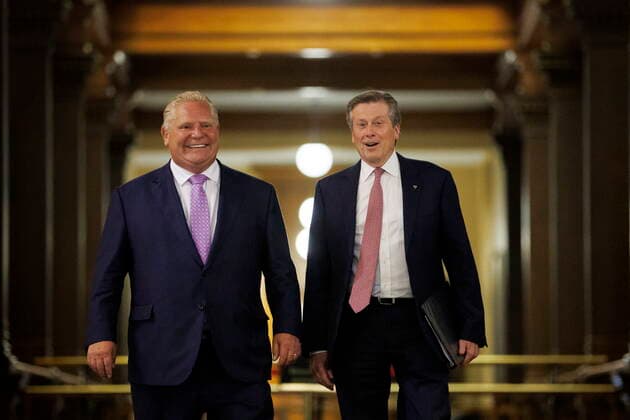 June 27, 2022, TORONTO, ON, Canada: Ontario premier Doug Ford walks alongside Toronto mayor John Tory on their way to a joint press conference inside QueenöÄÃ s Park in Toronto, Monday, June 27, 2022. TORONTO Canada  - ZUMAc35_ 20220627_zaf_c35_046 Copyright: xColexBurstonx