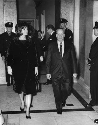 State of the Union Address, 12:33PM. First Lady Jacqueline Kennedy visits the Capitol Building in Washington, D.C., to listen to President John F. Kennedy deliver his annual address to the Congress on the State of the Union. Secret Service agent, Clint Hill, stands in background (motioning with hand). Copyright: xpiemagsx