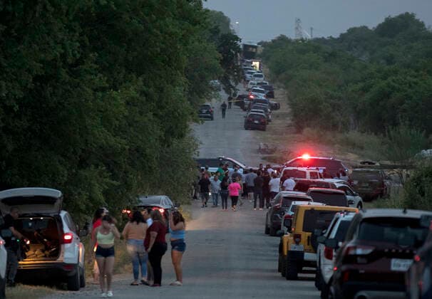 (220628) -- SAN ANTONIO (U.S.), June 28, 2022 -- People gather at the scene of an alleged human smuggling mass casualty event in San Antonio, Texas, the United States, on June 27, 2022. The death toll of migrants found on Monday inside a cloned and abandoned 18-wheeler in San Antonio has risen to 50, authorities said on Tuesday. (Photo by Xinhua) U.S.-TEXAS-SAN ANTONIO-MIGRANTS-DEATH TOLL NickxWagner 
