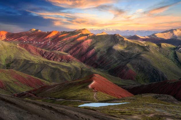 Creative Highlights World Breathtaking scenery of massive mountain range of Palccoyo with colorful grassy slopes and small lake against scenic sunset sky in Peru TheTrioStudio_PalccoyoMountainPeru_00001.jpg Copyright: xThexTrioxStudiox Model Released