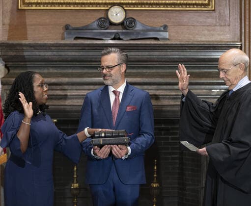 Justice Stephen Bryer (R) administers the Judicial Oath to U.S. Supreme Court Associate Justice Ketanji Brown Jackson as her husband Patrick Jackson holds the Bible in the East Conference Room of the Supreme Court Building in Washington, DC on Thursday, June 30, 2022. Photo Courtesy of the Collection of the Supreme Court of the United States  WAX20220630329 BONNIExCASH